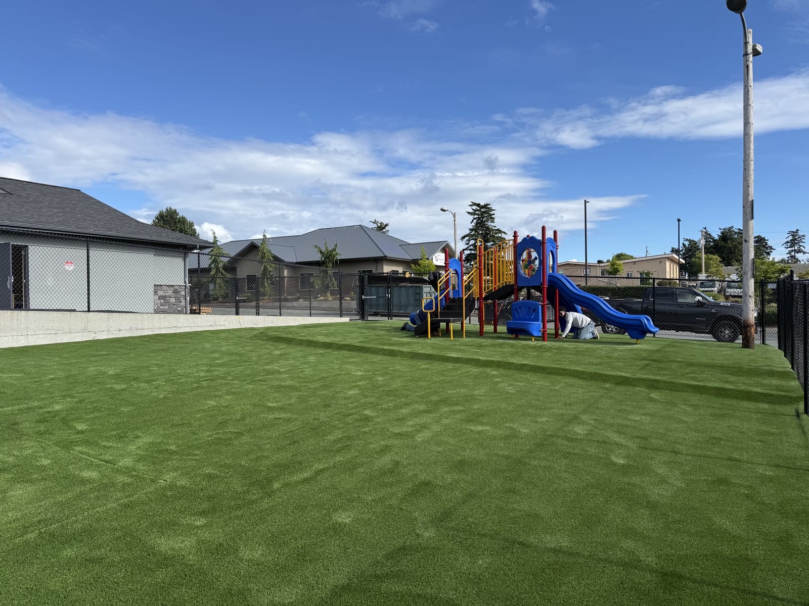 Colorful playground with slides on the turf play yard at Midway Blvd